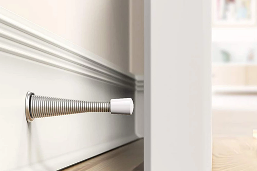 What are the advantages and disadvantages of installing a bathroom door stopper?